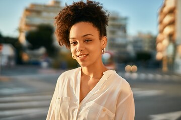 Poster - Young african american businesswoman smiling happy standing at the city.