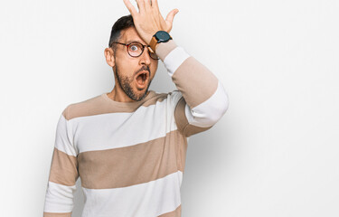 Sticker - Handsome man with beard wearing casual clothes and glasses surprised with hand on head for mistake, remember error. forgot, bad memory concept.