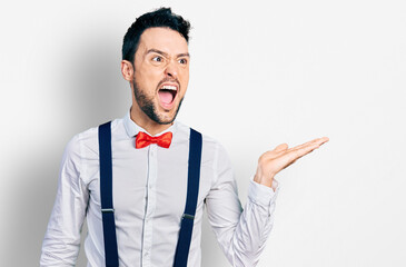 Poster - Hispanic man with beard presenting with open palm angry and mad screaming frustrated and furious, shouting with anger. rage and aggressive concept.