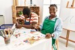 © Krakenimages.com - African american painter couple smiling happy painting pottery sitting on the table at art studio.