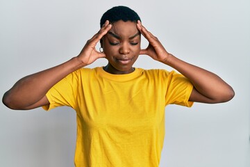 Poster - Young african american woman wearing casual yellow t shirt with hand on head, headache because stress. suffering migraine.