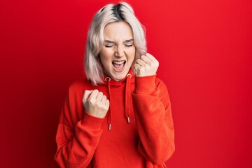 Poster - Young blonde girl wearing casual clothes looking positive and happy standing and smiling with a confident smile showing teeth