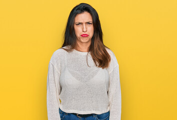 Poster - Beautiful hispanic woman wearing casual sweater depressed and worry for distress, crying angry and afraid. sad expression.