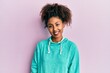 © Krakenimages.com - Beautiful african american woman with afro hair wearing casual sweatshirt looking positive and happy standing and smiling with a confident smile showing teeth