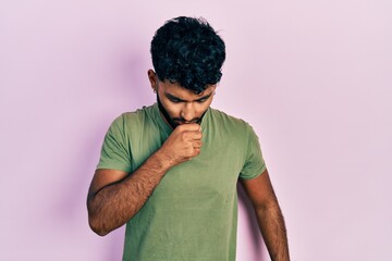 Poster - Arab man with beard wearing casual green t shirt feeling unwell and coughing as symptom for cold or bronchitis. health care concept.