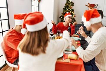 Group of young people smiling happy having christmas dinner at home.