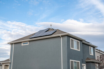 View at the corner of a two storey house with solar panels on the roof