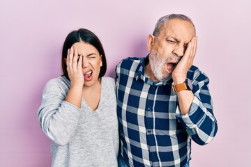 Canvas Print - Hispanic father and daughter wearing casual clothes yawning tired covering half face, eye and mouth with hand. face hurts in pain.