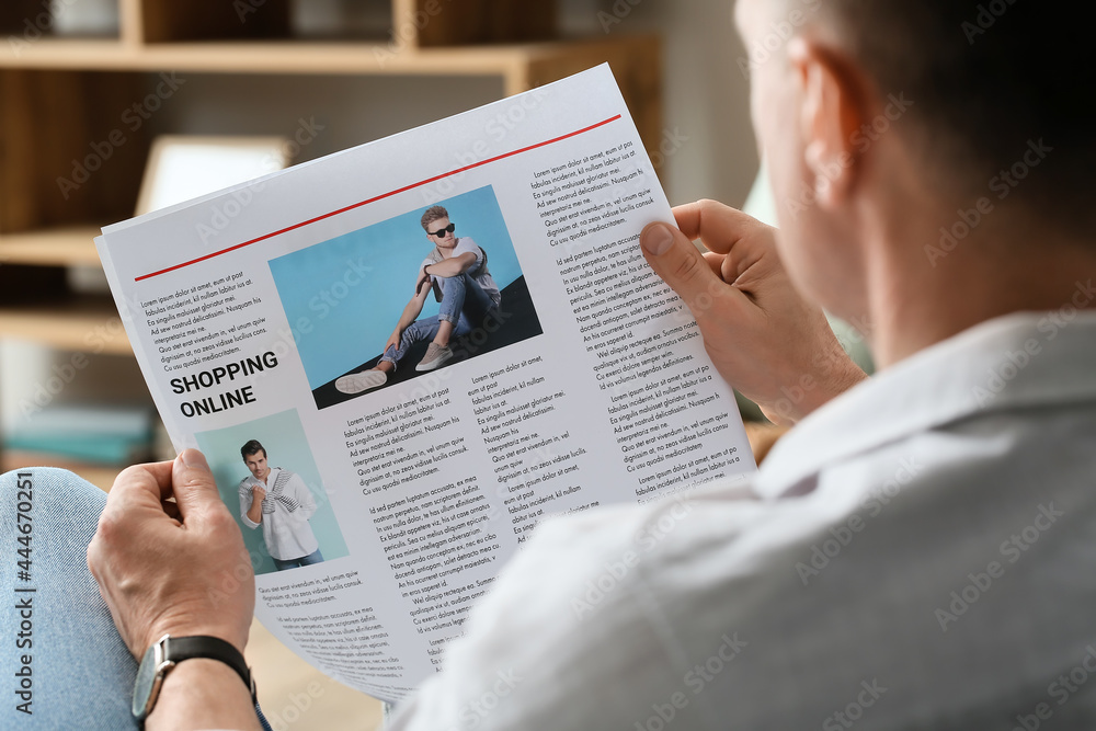 Mature man reading newspaper at home, closeup