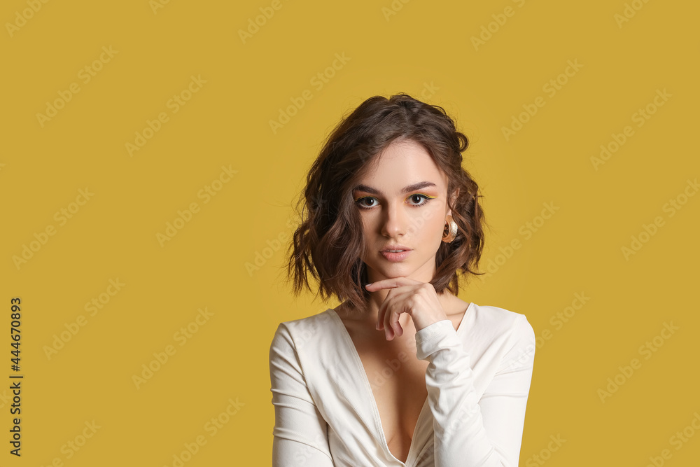 Beautiful young woman on color background