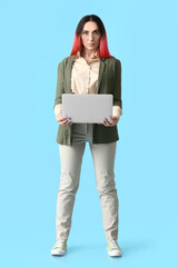 Wall Mural - Female programmer with laptop on color background