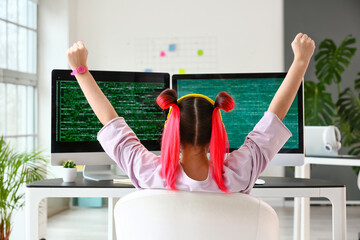 Happy female programmer working in office