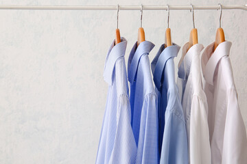 Wall Mural - Rack with clothes after dry-cleaning on light background
