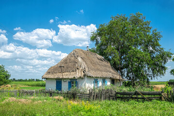 Poster - Old abandoned  clay house with thatched roof