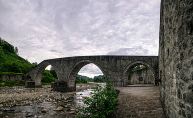 Canvas Print -  Ancient stone Turkish bridge and mountain river