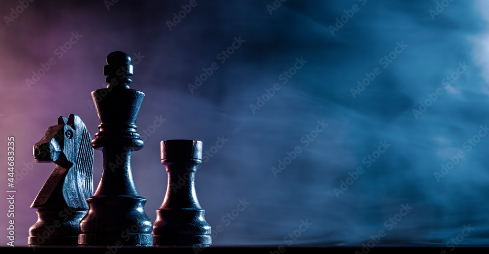 Chess pieces on a dark background - obrazy, fototapety, plakaty 