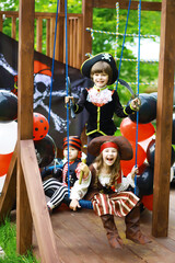 Children's party in a pirate style. Children in pirate costumes are playing on Halloween.