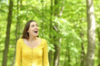 © PheelingsMedia - Amazed woman walking in a forest contemplating
