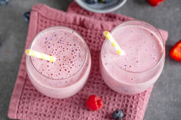 Wall Mural - Tasty berry milkshake in glasses