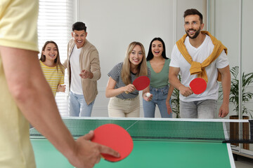 Sticker - Happy friends playing ping pong together indoors