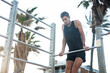 © JustLife - Sporty athletic man exercises at the beach. Handsome man training outdoors..