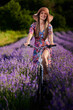 © Xalanx - Young woman riding her bicycle in a lavender field