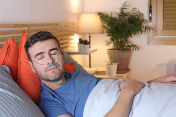 Man getting respiratory therapy in bed during the night