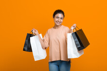 Indian Woman Holds Shopping Bags In Hands. Sale And Black Friday Concept