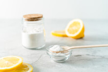 Eco Friendly Natural Cleaners, Jar With Baking Soda, Lemon And Wooden Spoon On Marble Table Background. Organic Ingredients For Homemade Cleaning. Zero Waste Concept.