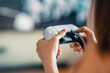 © oatawa - Closeup Hand of woman playing a computer games with joystick