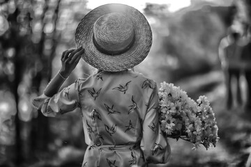 Wall Mural - vintage photo of a girl / sepia, black and white portrait of a beautiful young woman, happiness summ