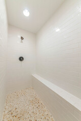 Wall Mural - Inside a white shower room with tile flooring and walls