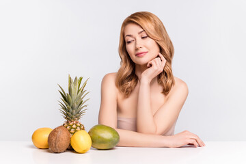 Poster - Portrait of attractive curious woman looking at citrus fruits choosing juice weight loss menu dietary isolated over grey pastel color background