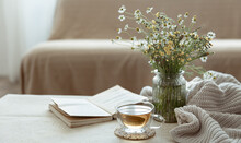 Cozy Home Composition With A Cup Of Tea, A Book And Flowers Copy Space.