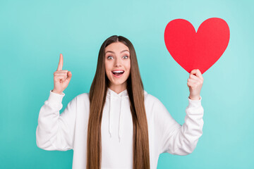 Sticker - Photo of happy cheerful brown haired woman idea hold hand red paper heart shape isolated on teal color background