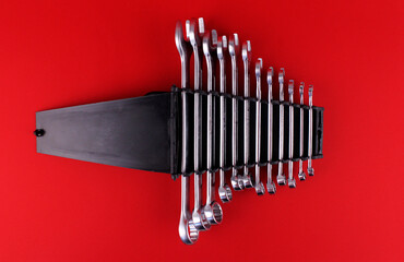 Wrenches of different sizes on a red background