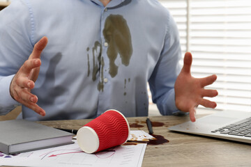 Poster - Man with spilled coffee over his workplace and shirt, closeup