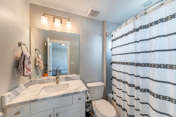 Small bathroom inside a room with ambient lightnings and bathtub