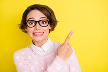 Photo Portrait Amazed Funny Girl In Glasses Pointing Finger Empty Space Isolated Vibrant Yellow Color Background