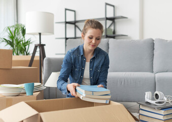 Wall Mural - Young woman moving in her new apartment