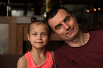 Wall Mural - Portrait of father and daughter in restaurant