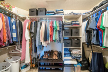 Organized Small Walk In Wardrobe With Clothes And Linen Storage Boxes