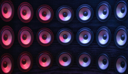 Wall Mural - Group of sound speakers in neon light on black.