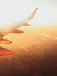 Hazy airplane wing view sunny cinematic panorama during flight over land copy paste vertical background
