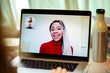© Martin Barraud/Caia Image - Smiling woman video conferencing on laptop screen