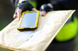 © Martin Barraud/Caia Image - Close up courier with smart phone delivering envelope