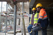 © Paul Bradbury/Caia Image - Male construction workers talking at construction site