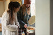 © Sam Edwards/Caia Image - Young couple cooking stew in tiny cabin
