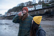 © Sam Edwards/Caia Image - Portrait young couple drinking wine on winter beach