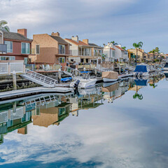 Canvas Print - Square Huntington Beach California scenery with homes overlooking the road and canal